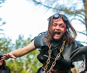 A photo of an attendee participating in a LARPing event.