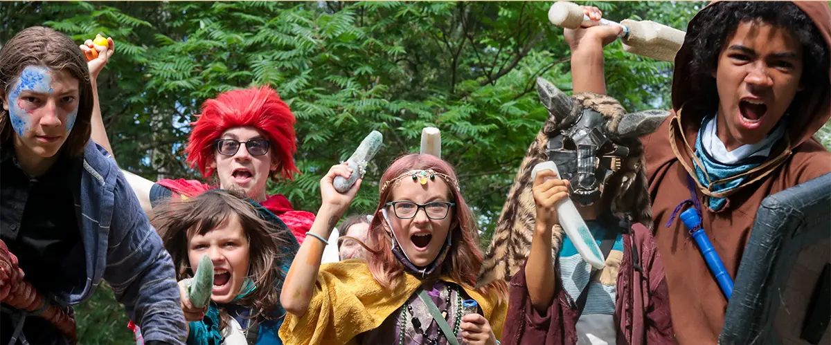 A group photo of children LARPing.